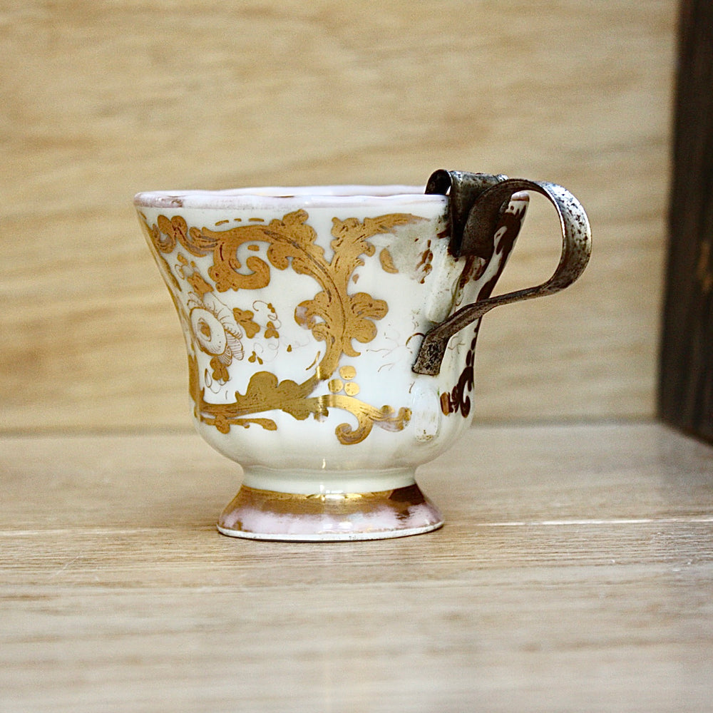 
                  
                    a cup by kpm with folk art appeal.
                  
                