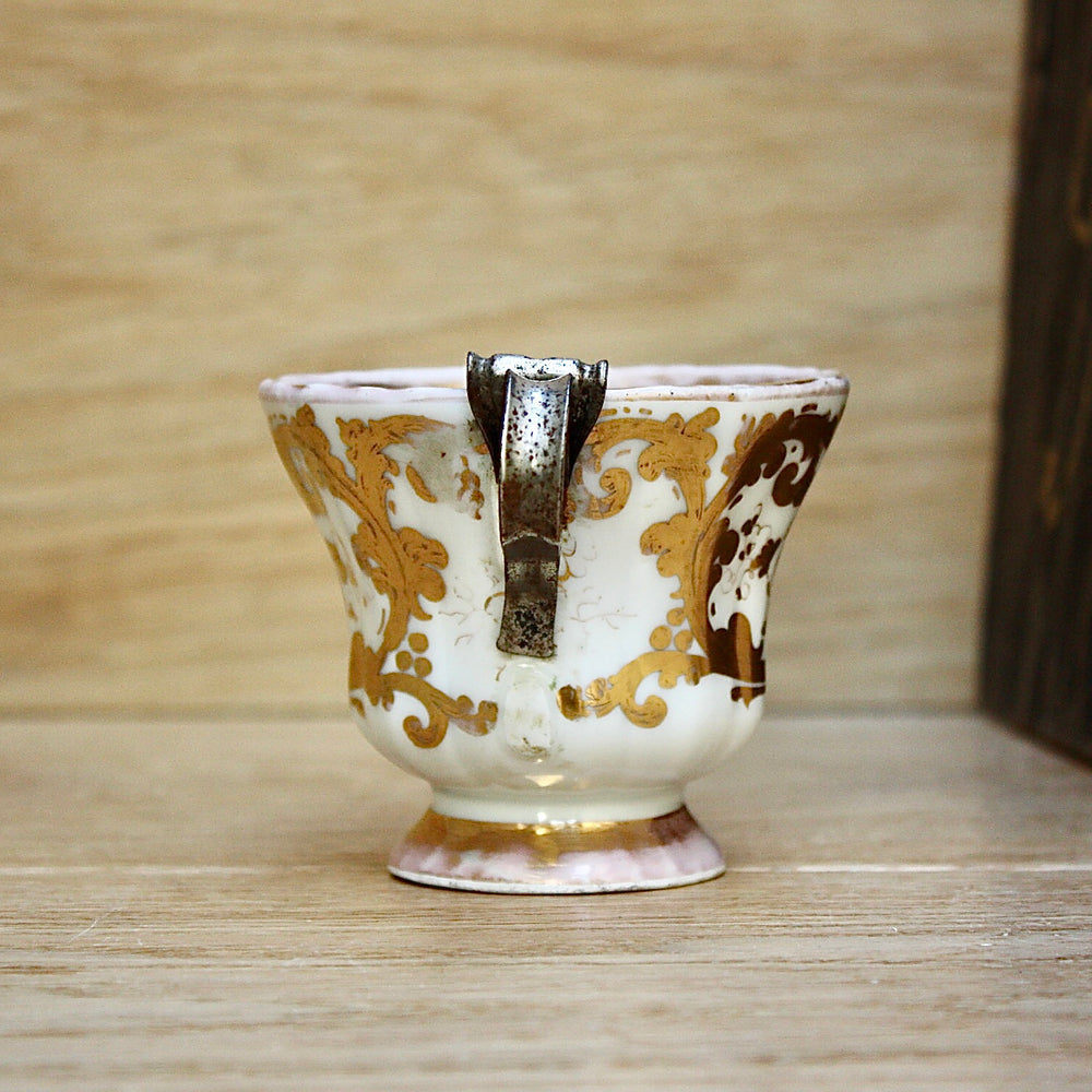 
                  
                    a cup by kpm with folk art appeal.
                  
                