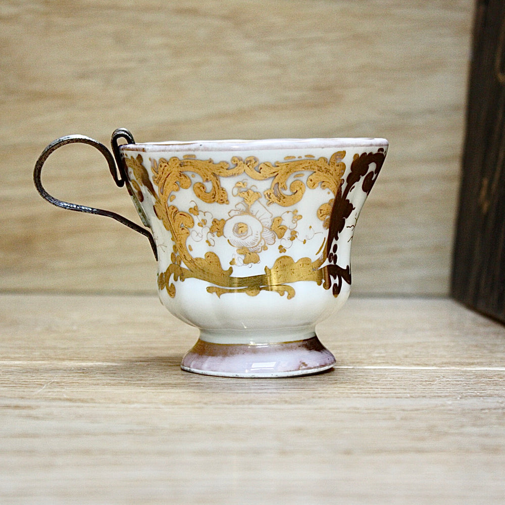 a cup by kpm with folk art appeal.