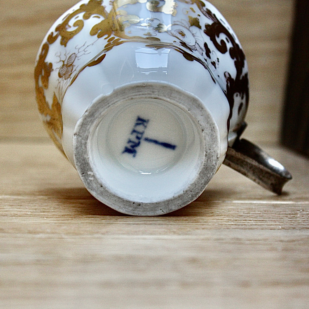
                  
                    a cup by kpm with folk art appeal.
                  
                