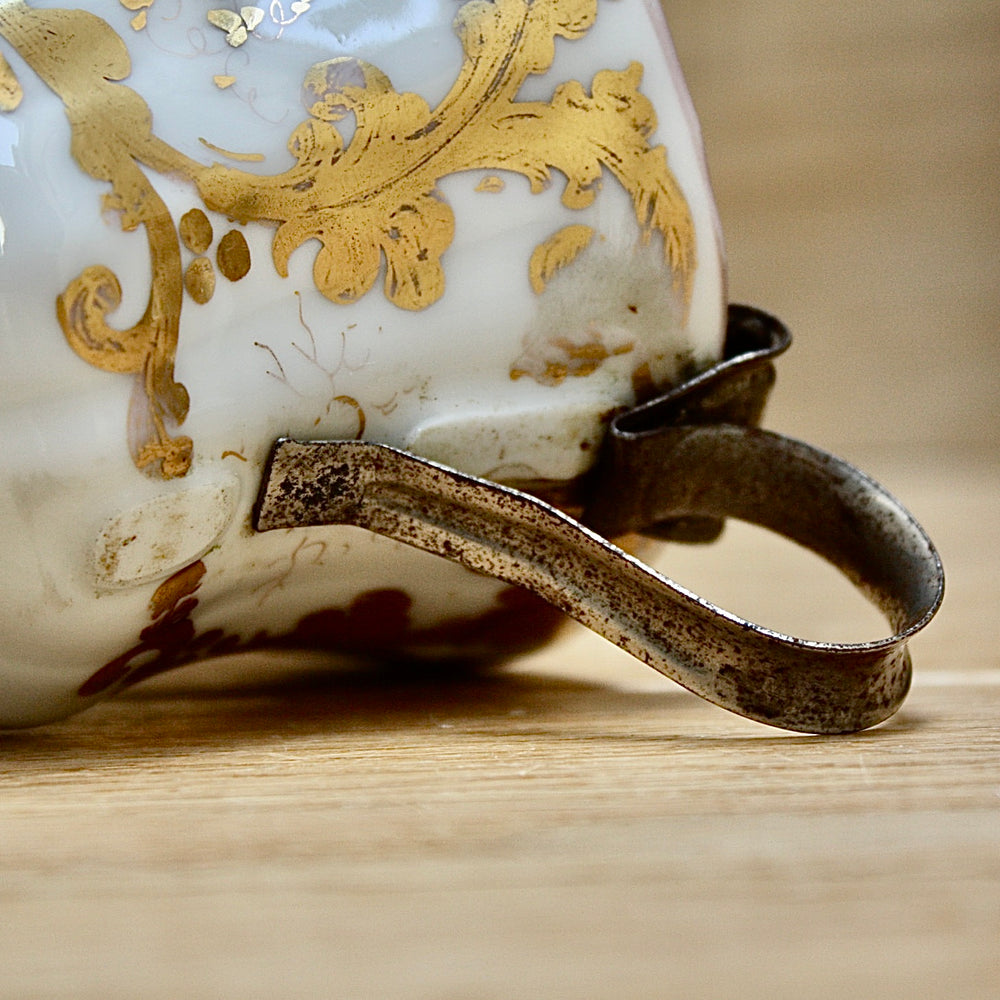 
                  
                    a cup by kpm with folk art appeal.
                  
                