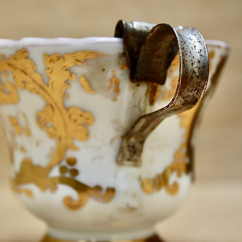 
                  
                    a cup by kpm with folk art appeal.
                  
                