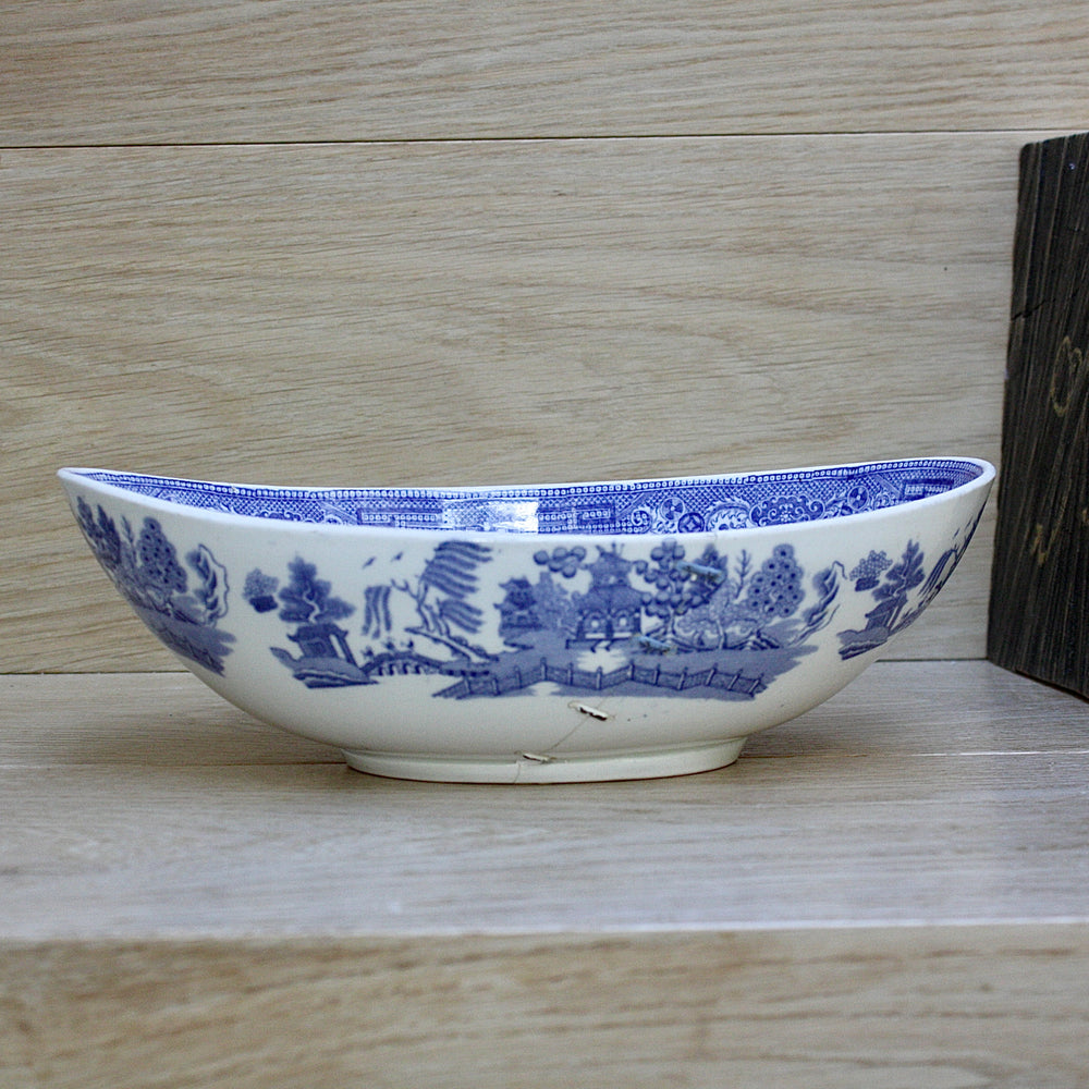 
                  
                    a staple repaired wedgwood willow pattern fruit bowl.
                  
                