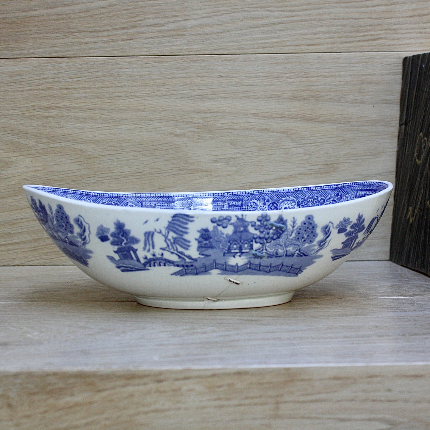 
                  
                    a staple repaired wedgwood willow pattern fruit bowl.
                  
                