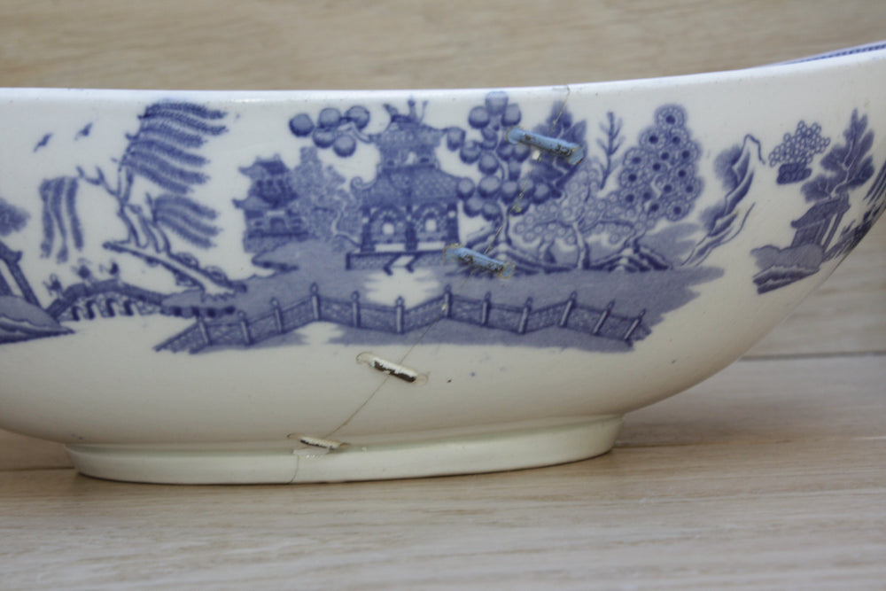 
                  
                    a staple repaired wedgwood willow pattern fruit bowl.
                  
                