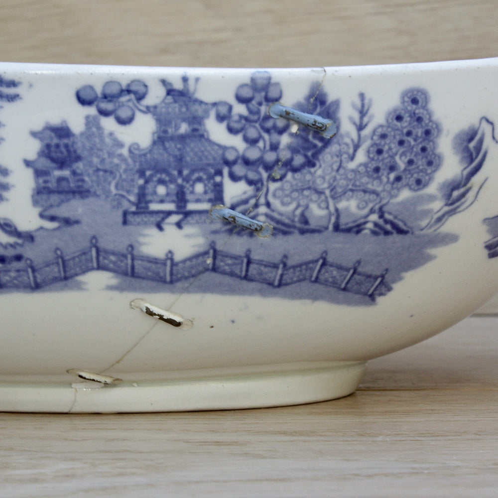 
                  
                    a staple repaired wedgwood willow pattern fruit bowl.
                  
                