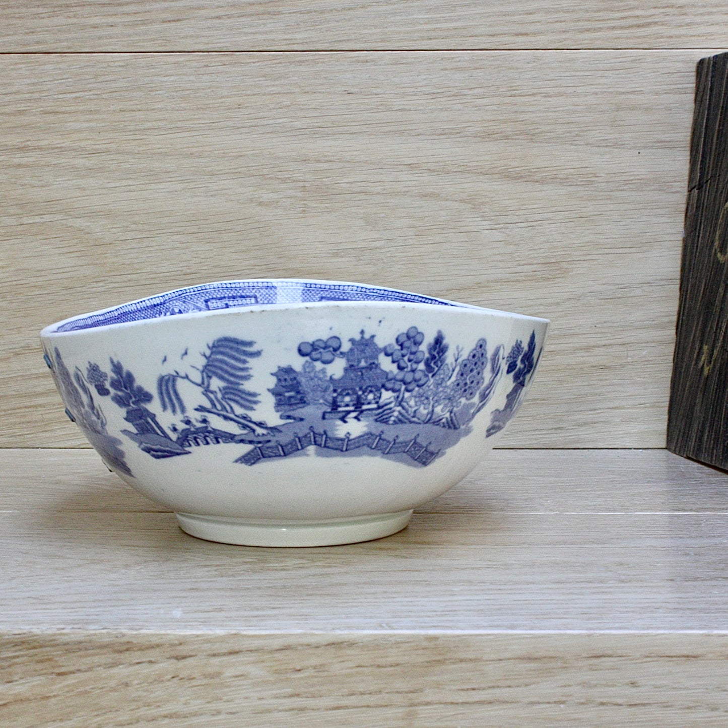 
                  
                    a staple repaired wedgwood willow pattern fruit bowl.
                  
                