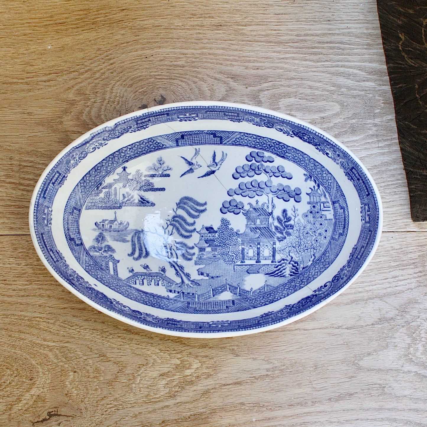 
                  
                    a staple repaired wedgwood willow pattern fruit bowl.
                  
                