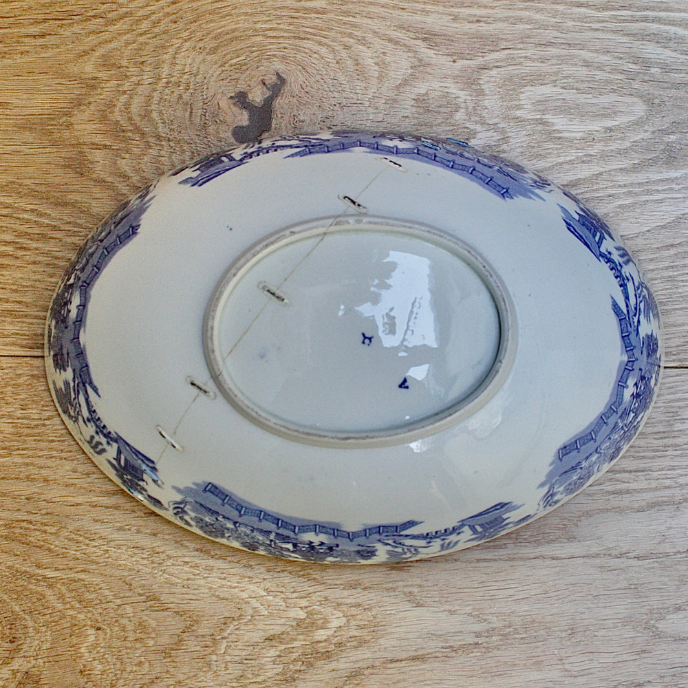 
                  
                    a staple repaired wedgwood willow pattern fruit bowl.
                  
                