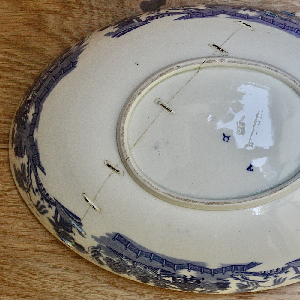 
                  
                    a staple repaired wedgwood willow pattern fruit bowl.
                  
                