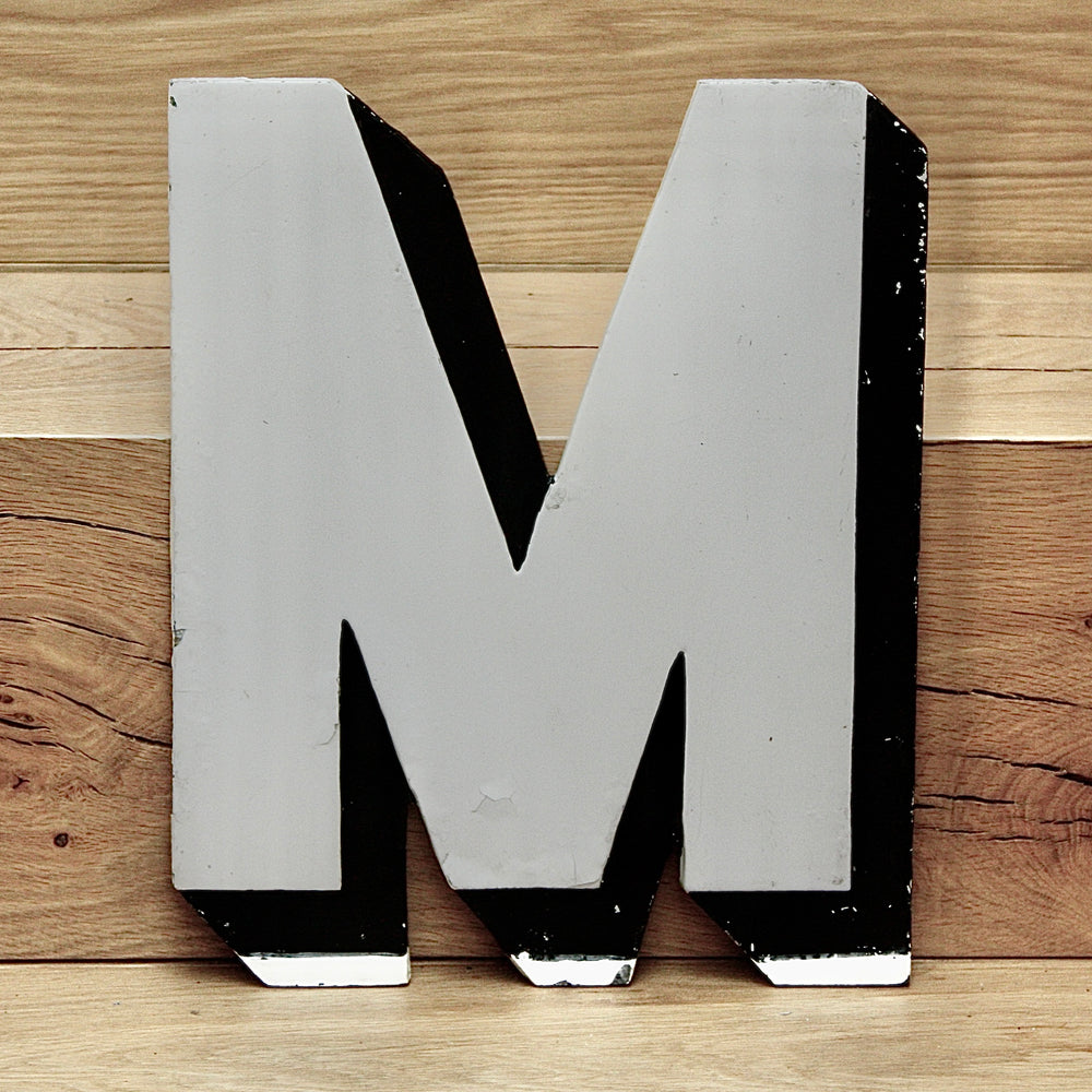 a vintage west end cinema / theatre marquee metal capital letter m