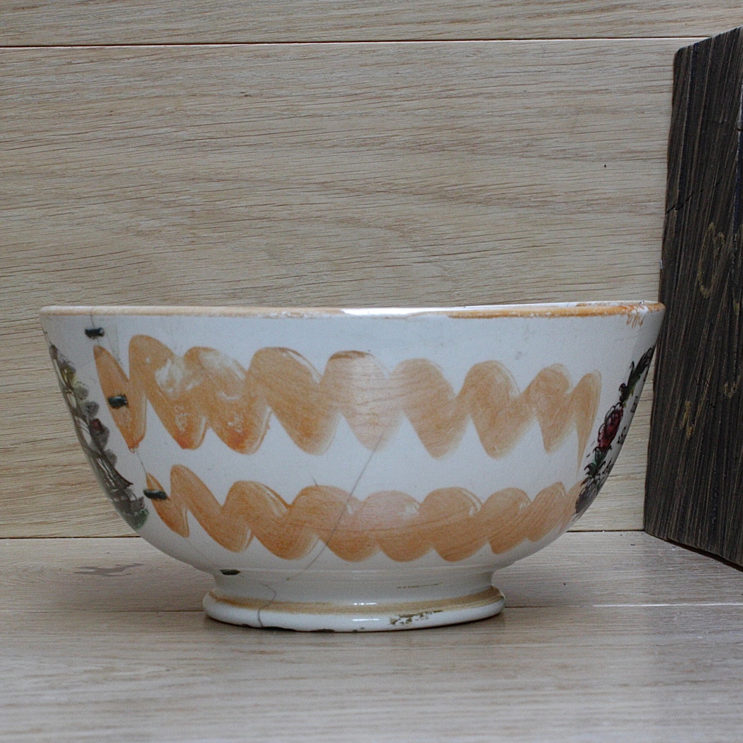 
                  
                    a glorious sunderland orange lustre bowl with an impressive staple repair.
                  
                