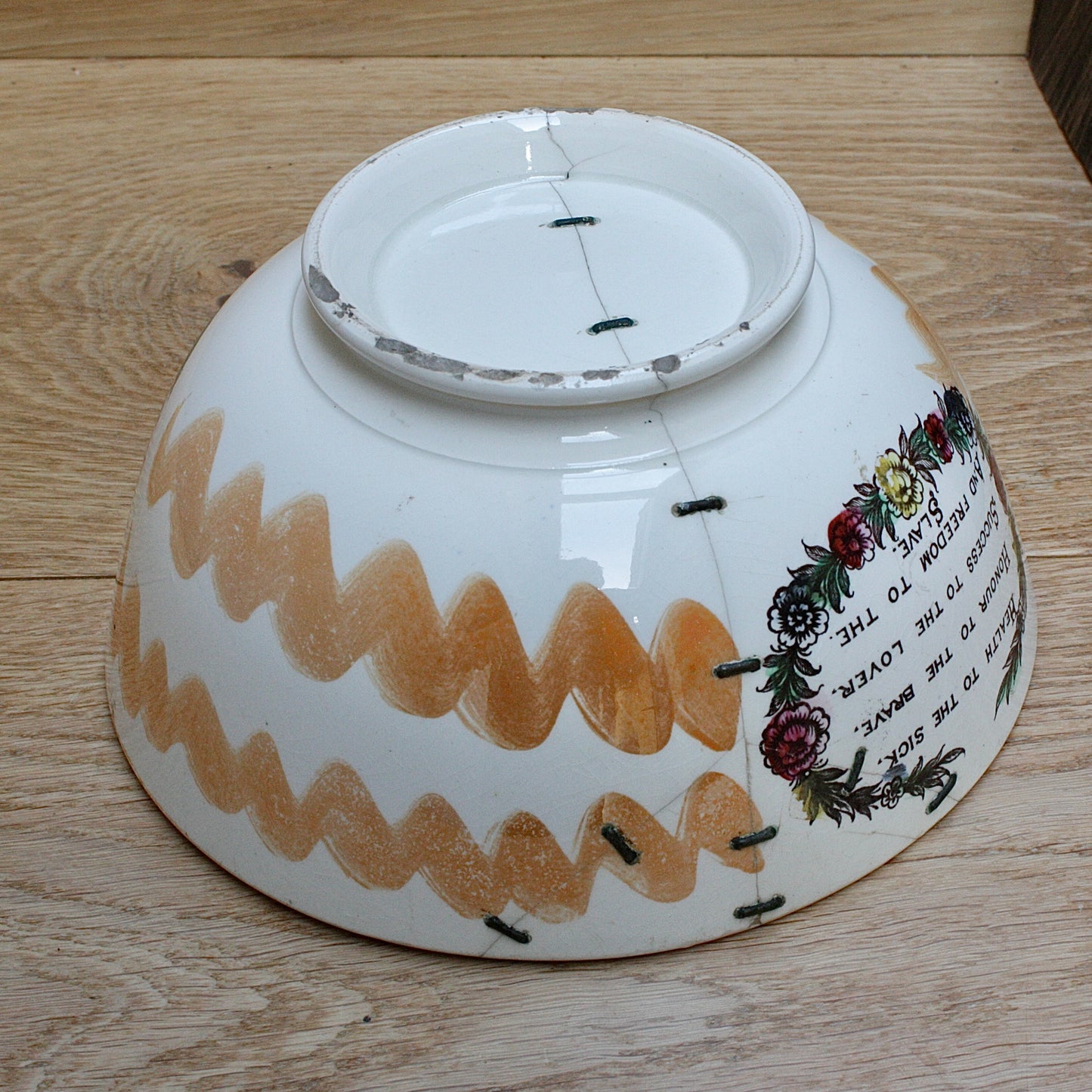 
                  
                    a glorious sunderland orange lustre bowl with an impressive staple repair.
                  
                