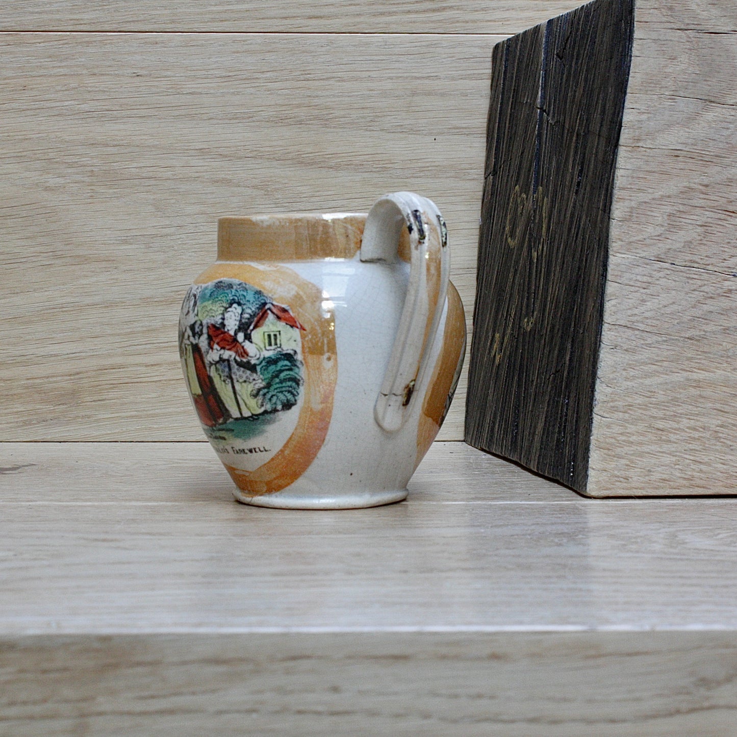 
                  
                    a small antique sunderland orange lustre jug with staple repair.
                  
                