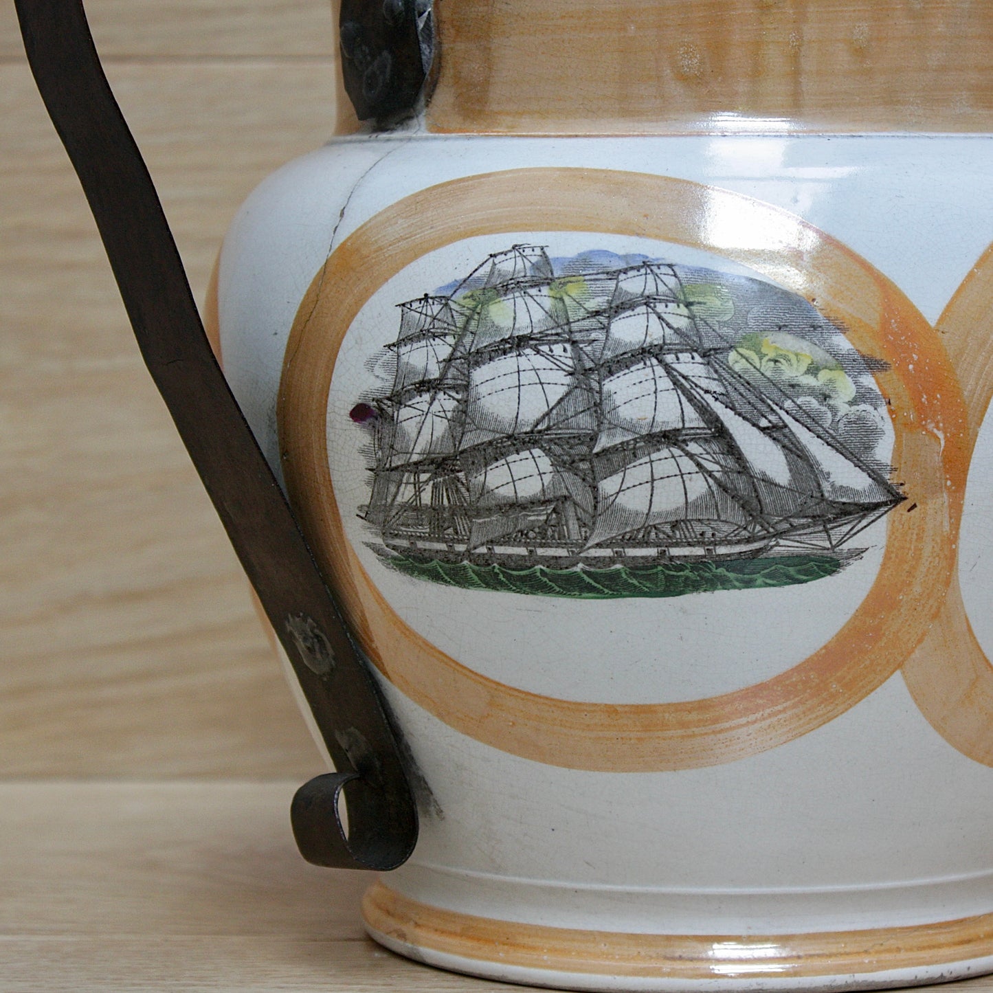 
                  
                    a huge sunderland orange lustre jug with a tinker made copper handle.
                  
                