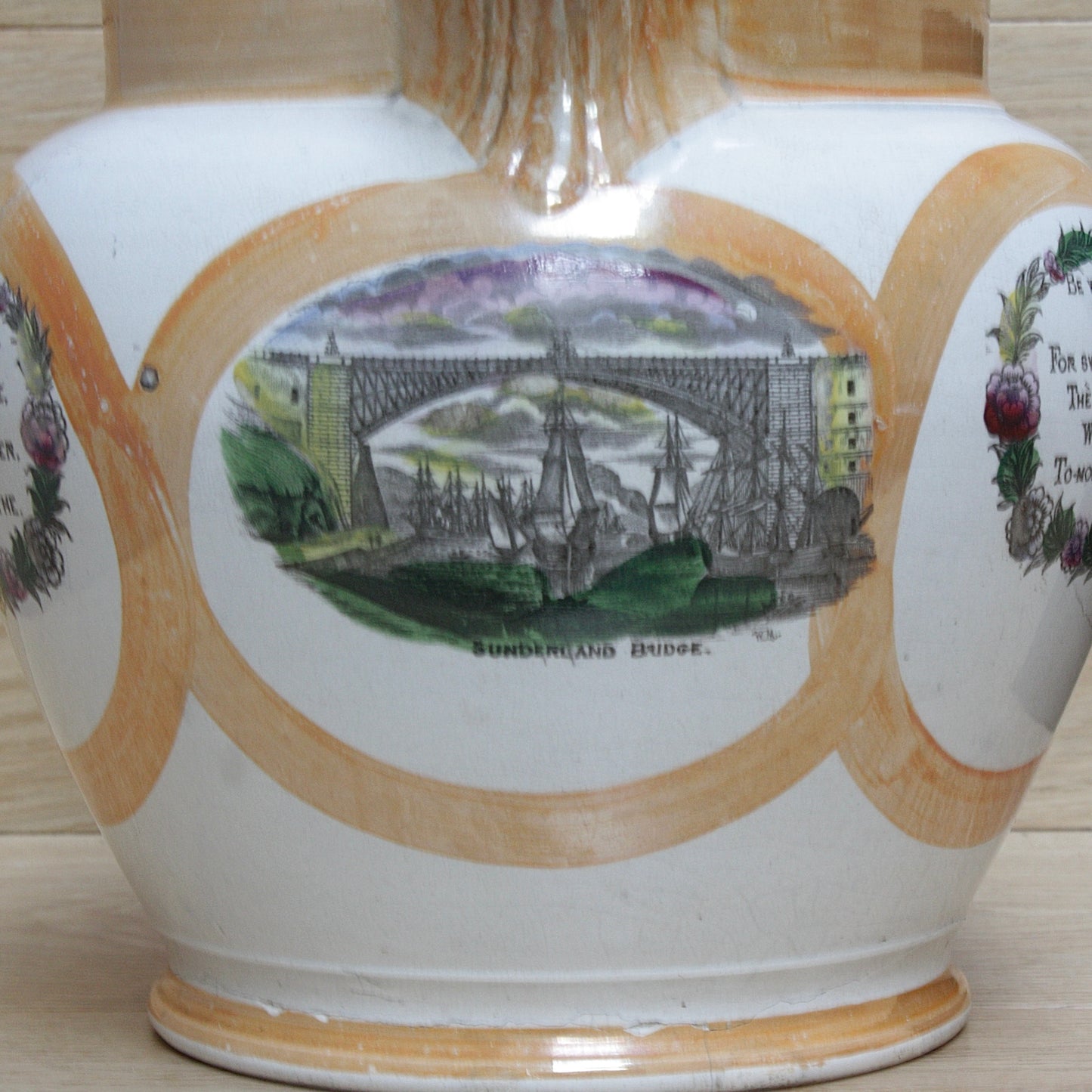 
                  
                    a huge sunderland orange lustre jug with a tinker made copper handle.
                  
                