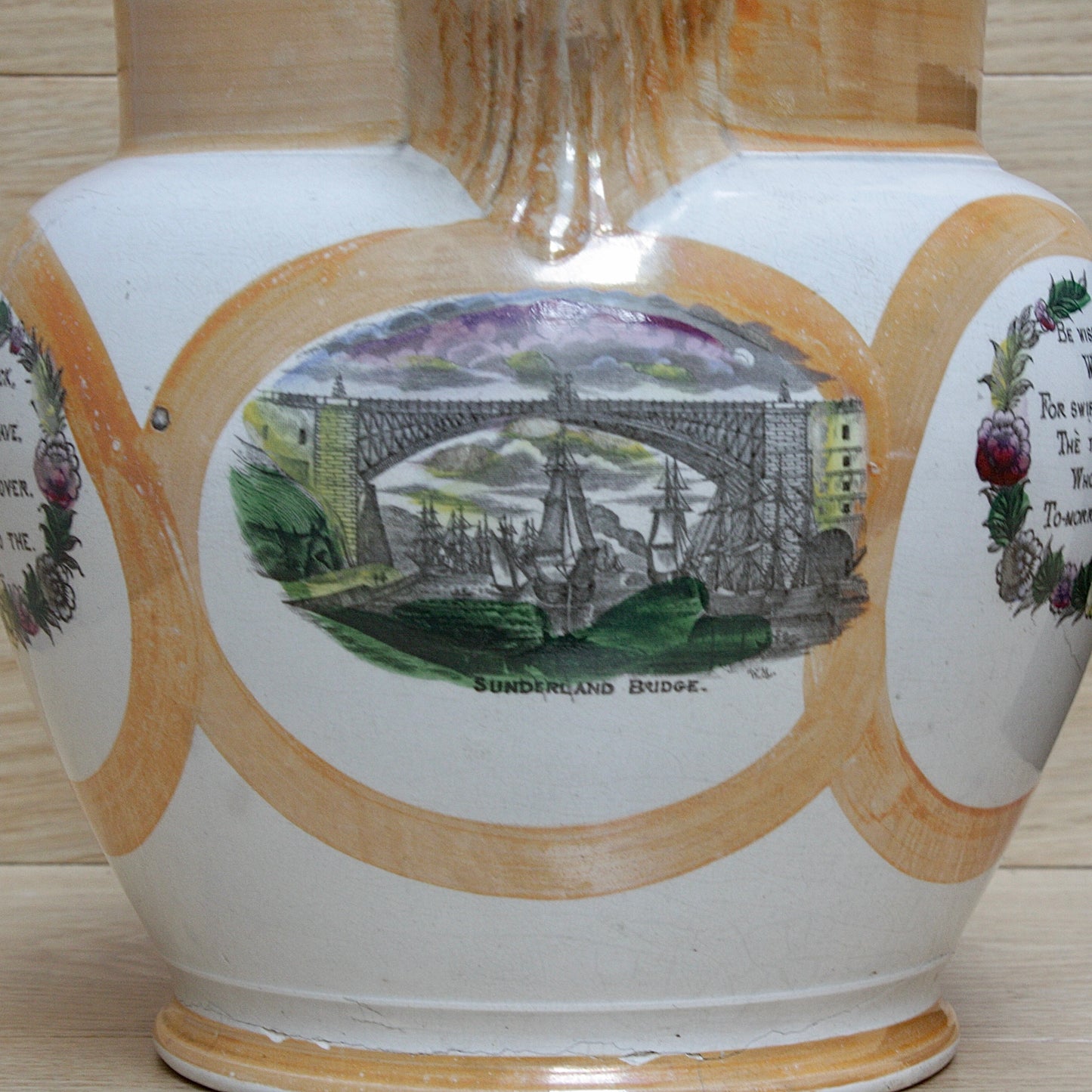 
                  
                    a huge sunderland orange lustre jug with a tinker made copper handle.
                  
                