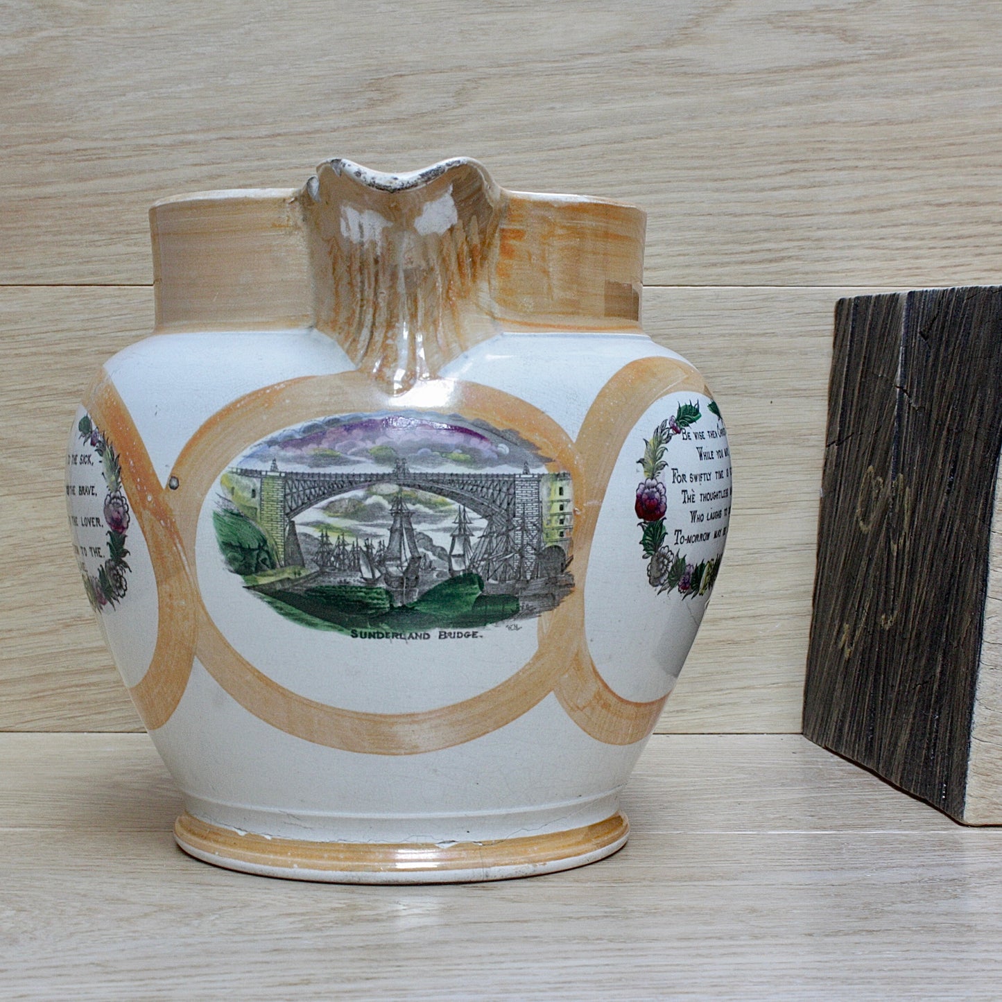 
                  
                    a huge sunderland orange lustre jug with a tinker made copper handle.
                  
                