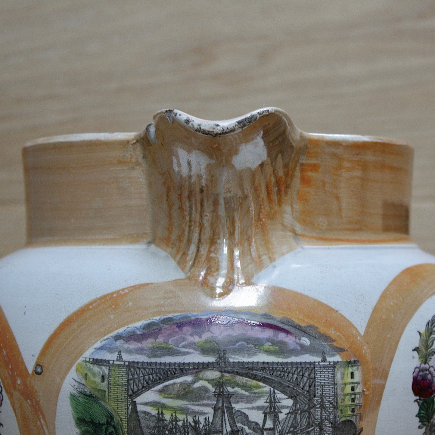 
                  
                    a huge sunderland orange lustre jug with a tinker made copper handle.
                  
                