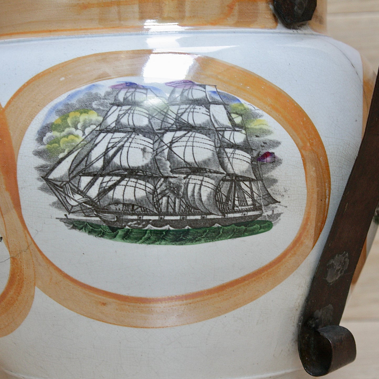 
                  
                    a huge sunderland orange lustre jug with a tinker made copper handle.
                  
                