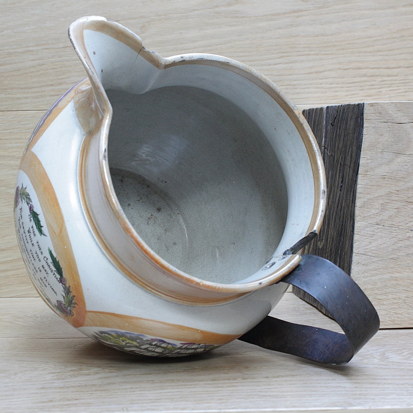 
                  
                    a huge sunderland orange lustre jug with a tinker made copper handle.
                  
                