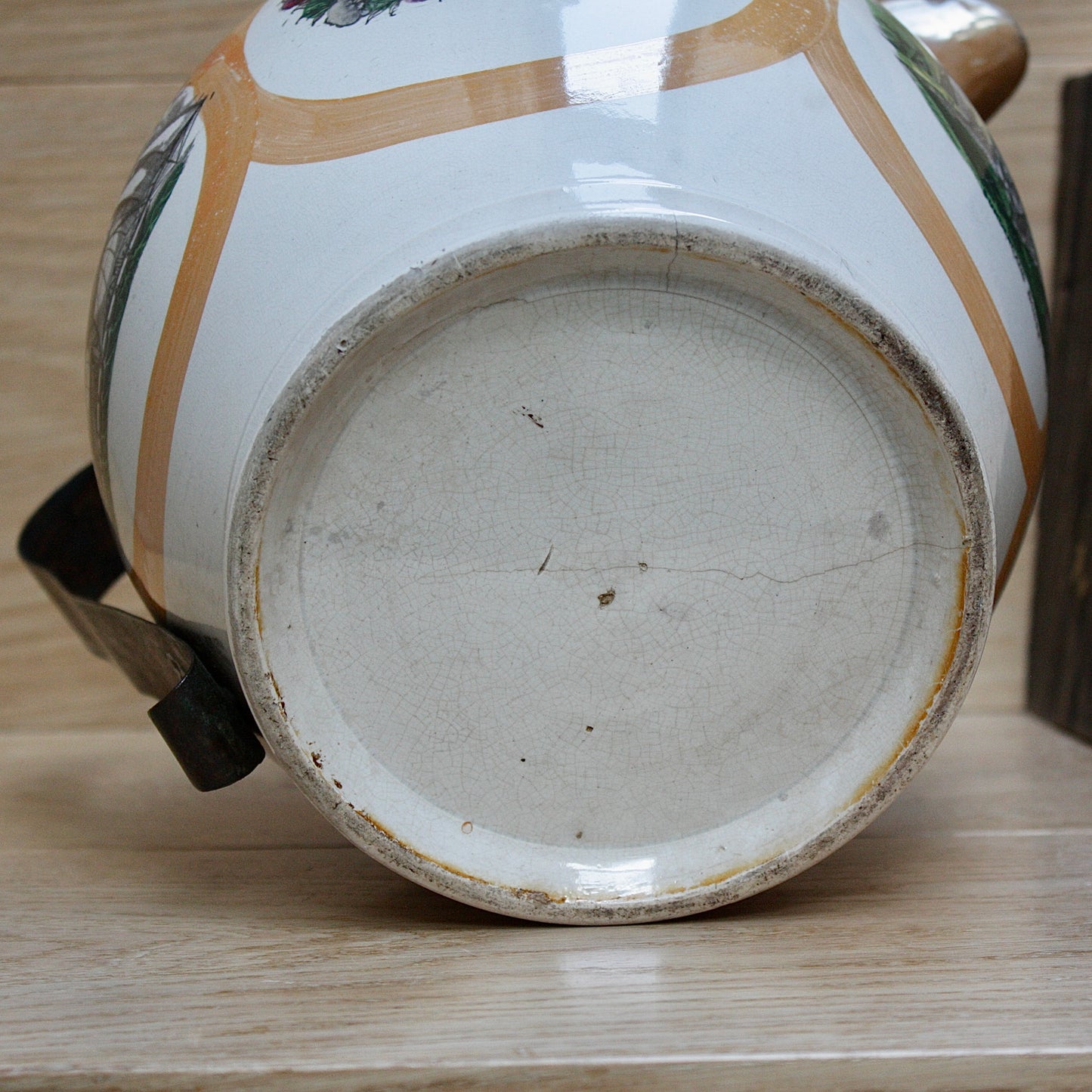 
                  
                    a huge sunderland orange lustre jug with a tinker made copper handle.
                  
                