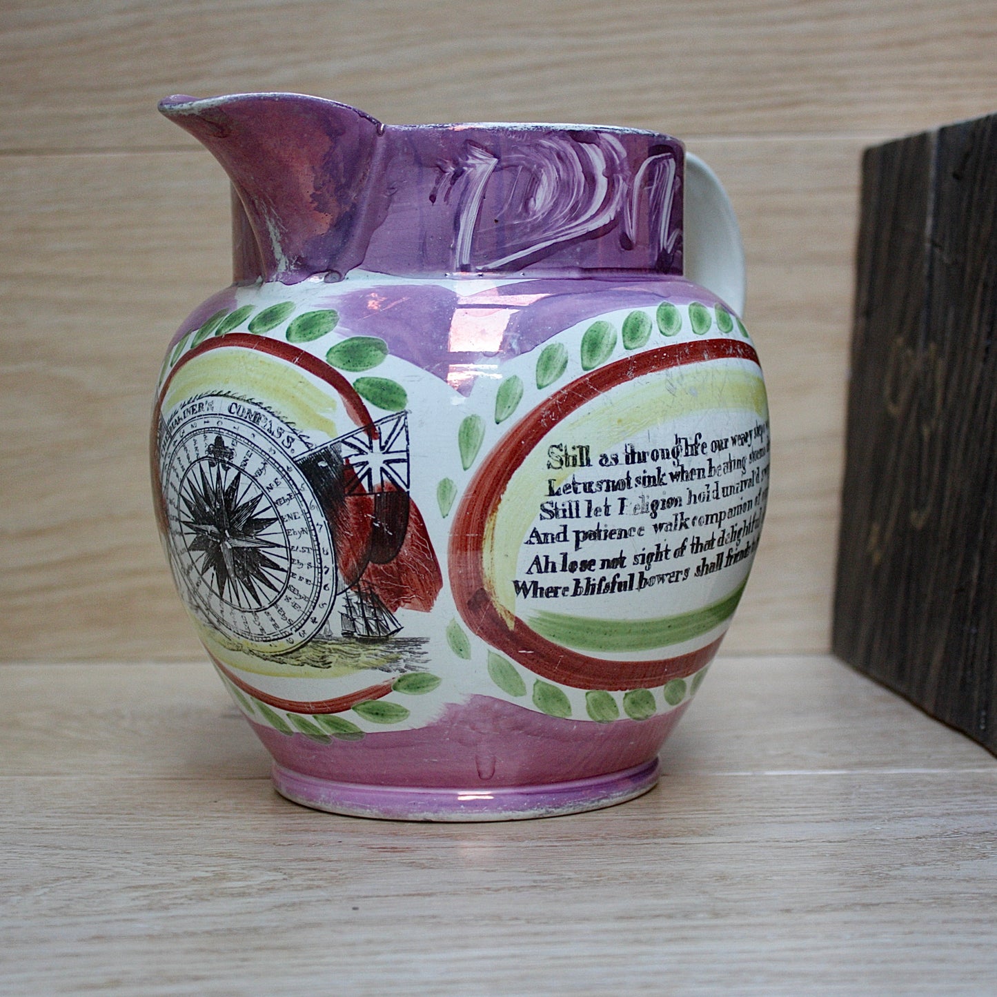 
                  
                    a large antique purple sunderland lustre jug with a single staple repair.
                  
                