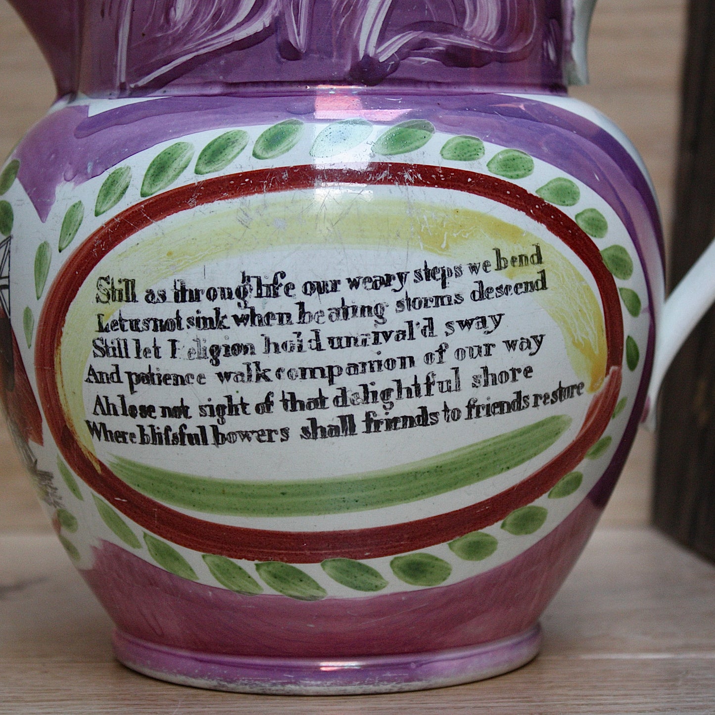 
                  
                    a large antique purple sunderland lustre jug with a single staple repair.
                  
                