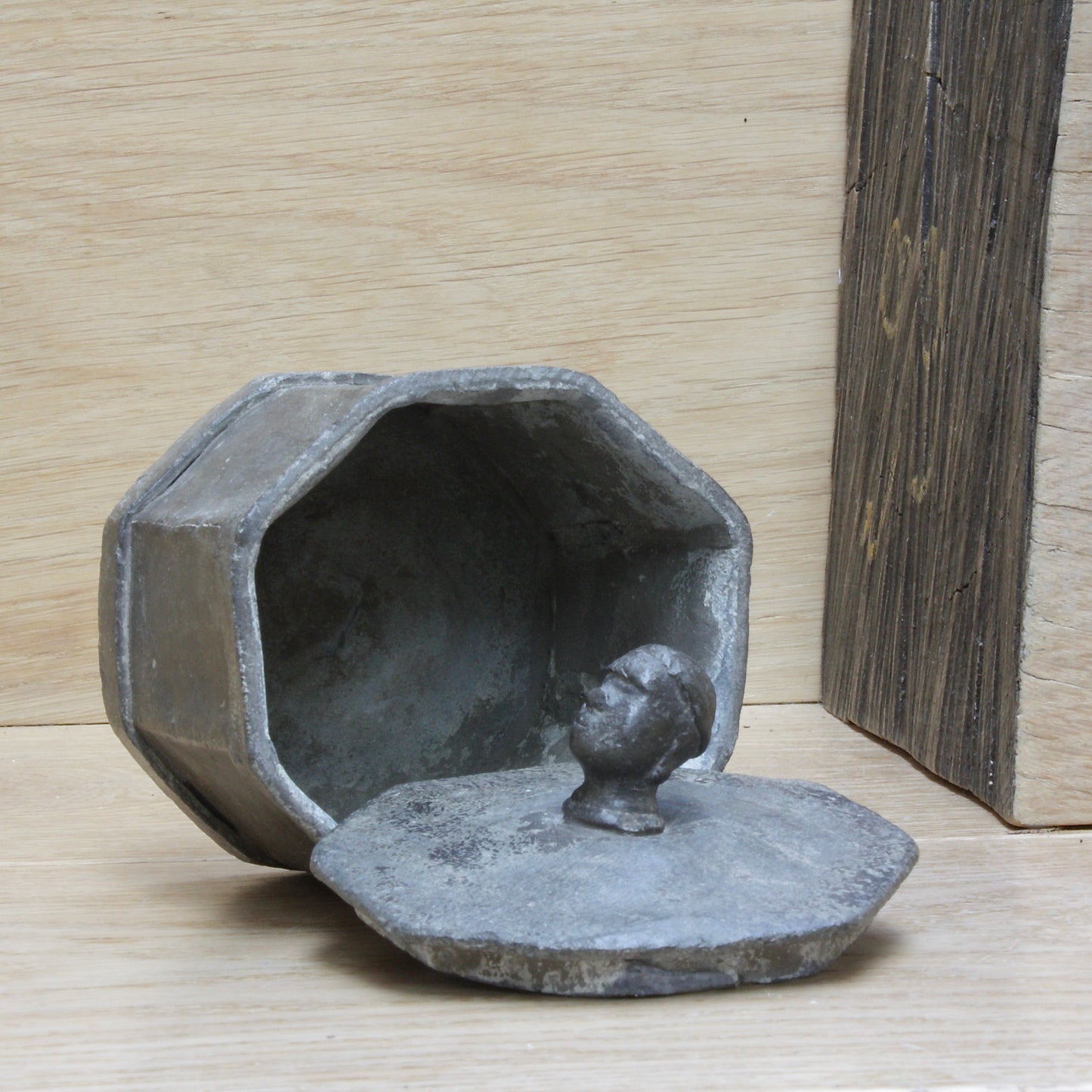
                  
                    an early antique Georgian lead tobacco box.
                  
                