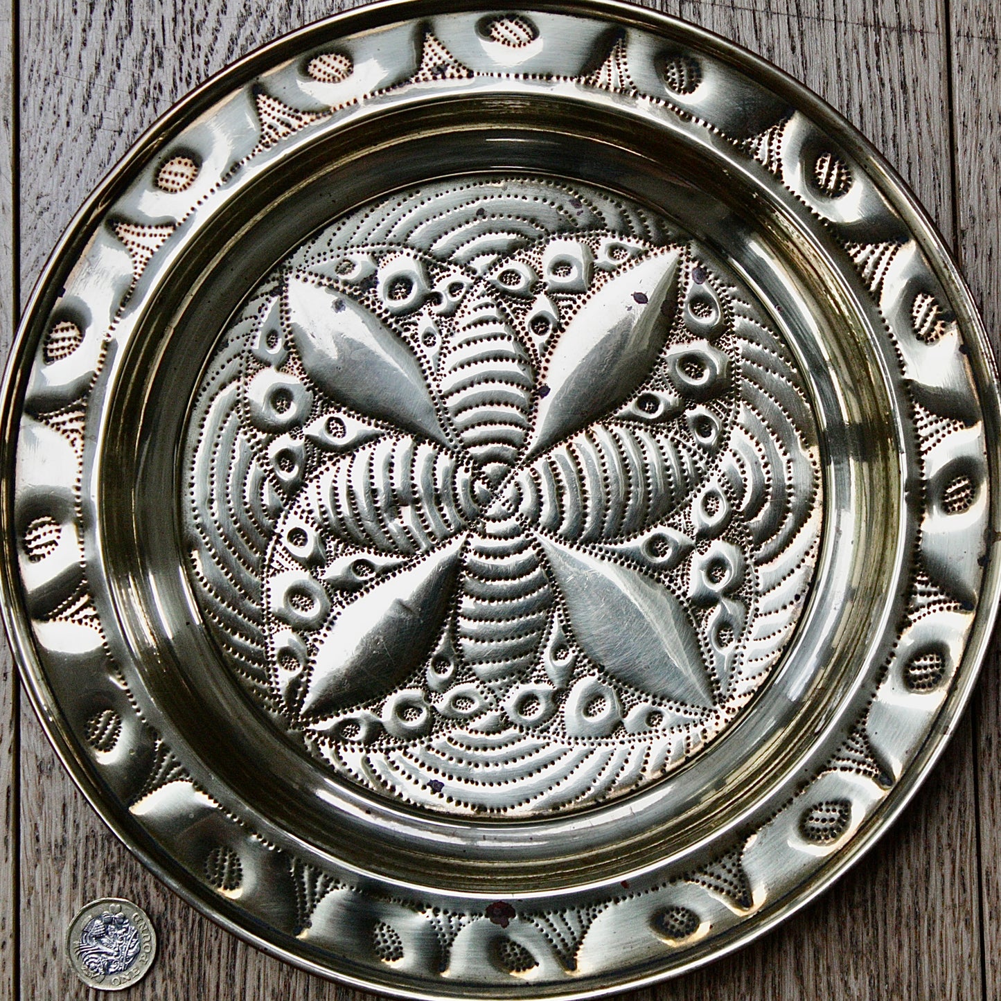 
                  
                    a small african efik hand  embossed brass dish.
                  
                