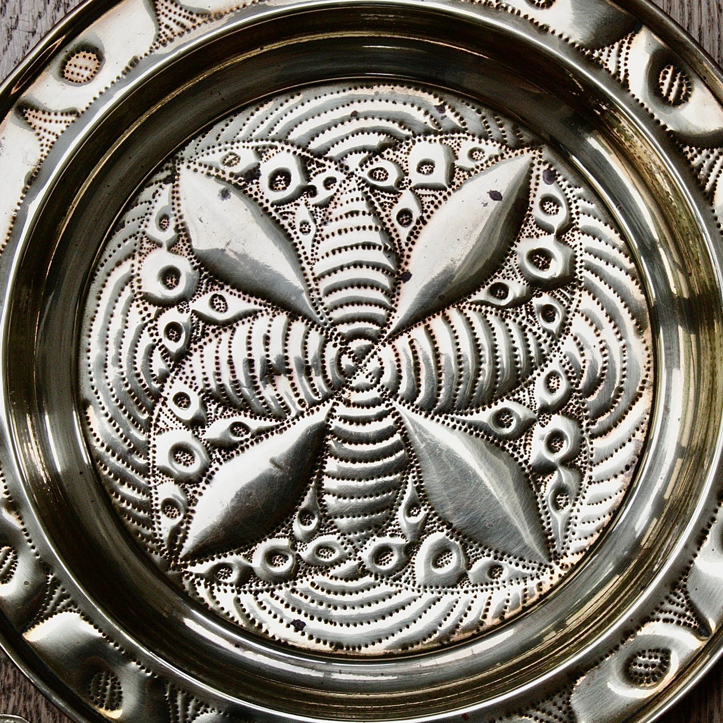 
                  
                    a small african efik hand  embossed brass dish.
                  
                