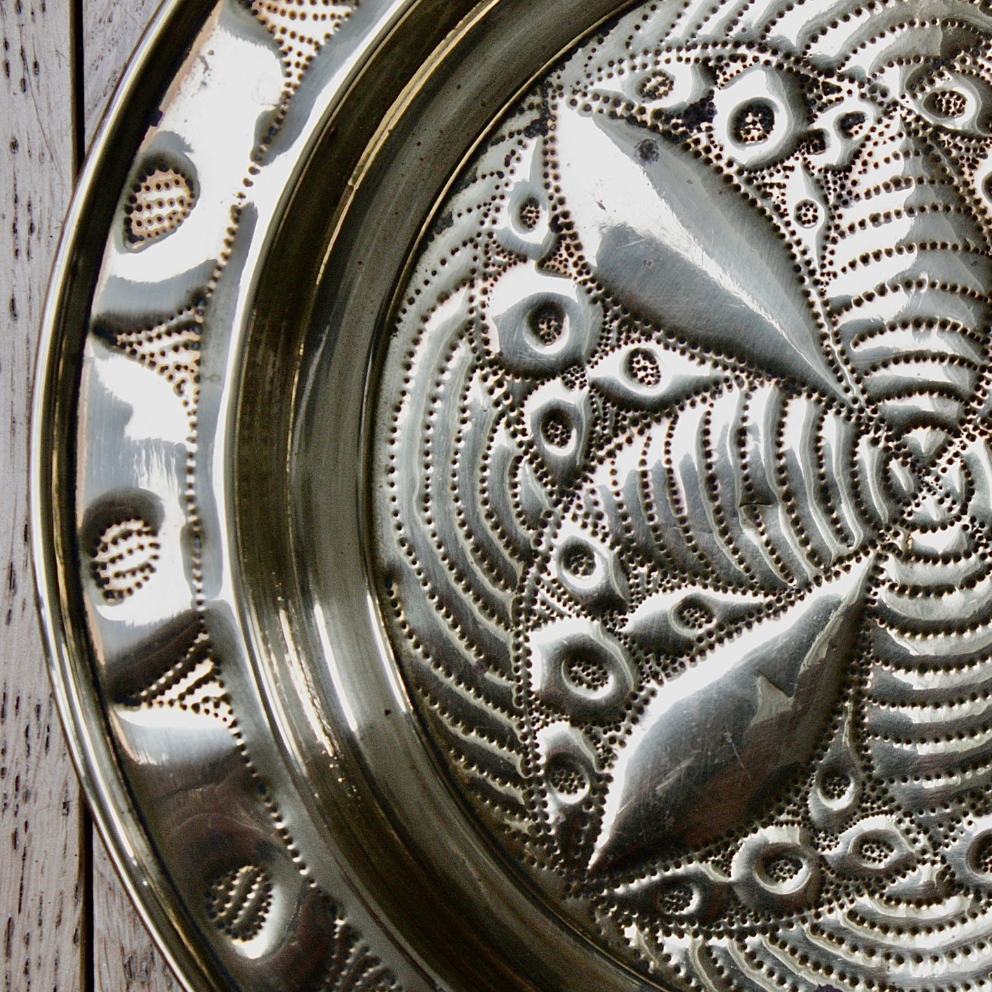 
                  
                    a small african efik hand  embossed brass dish.
                  
                