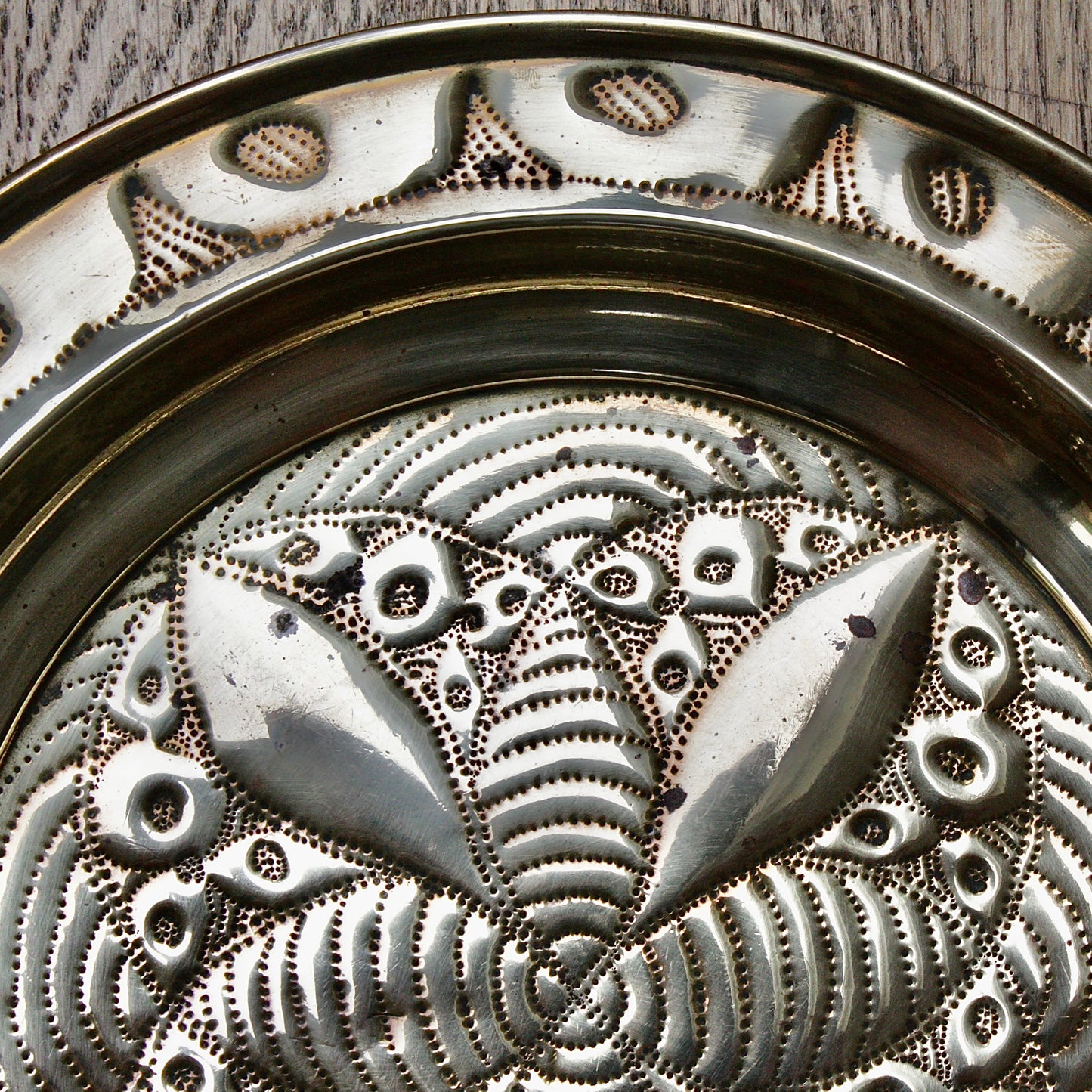 
                  
                    a small african efik hand  embossed brass dish.
                  
                