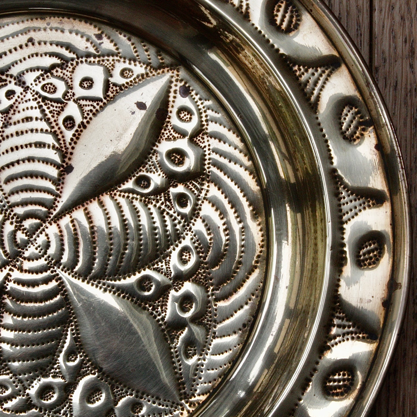 
                  
                    a small african efik hand  embossed brass dish.
                  
                