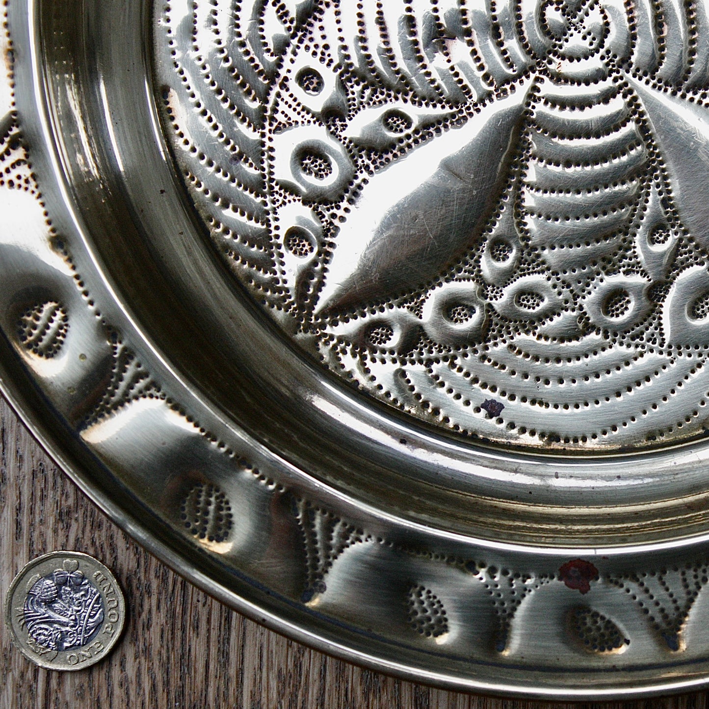 
                  
                    a small african efik hand  embossed brass dish.
                  
                
