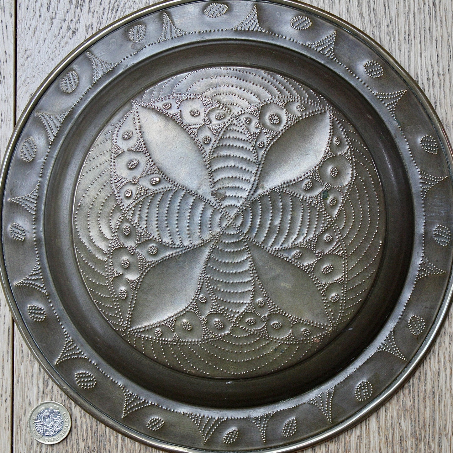 
                  
                    a small african efik hand  embossed brass dish.
                  
                