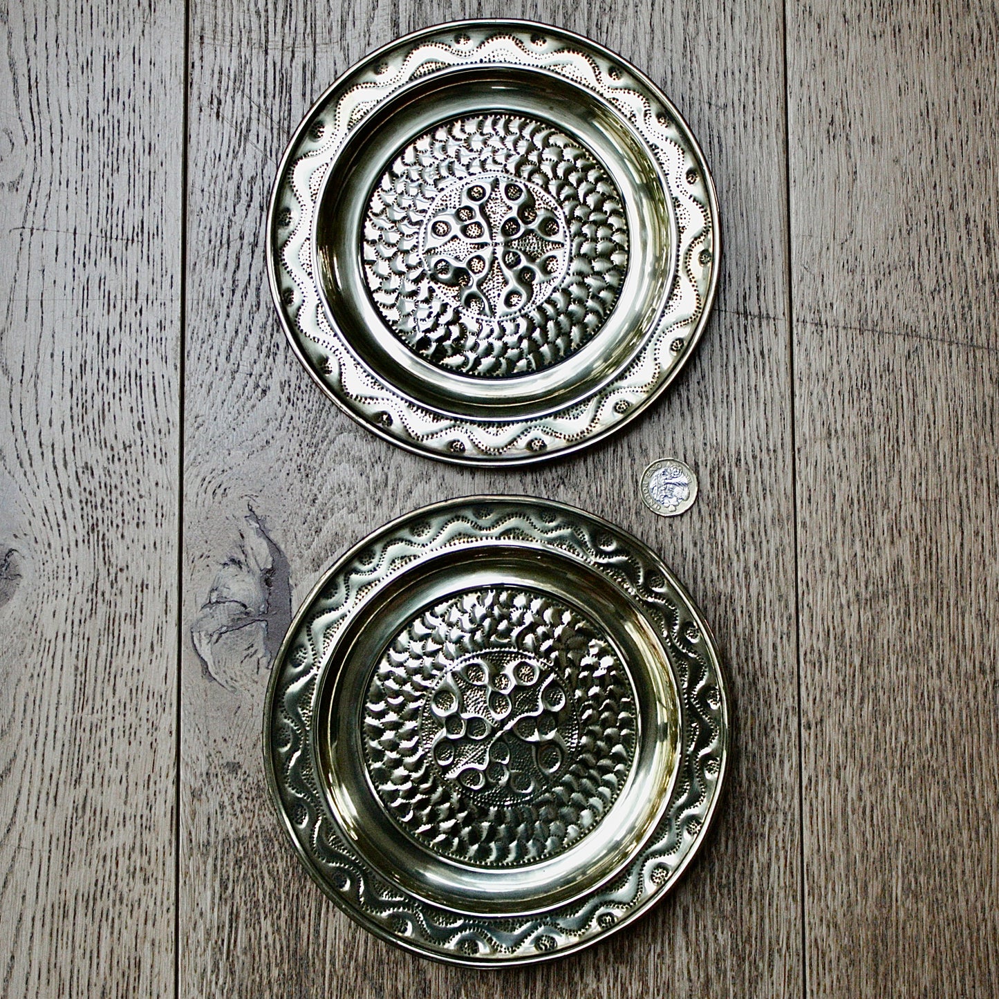 
                  
                    a pair of small embossed brass dishes from old calabar.
                  
                