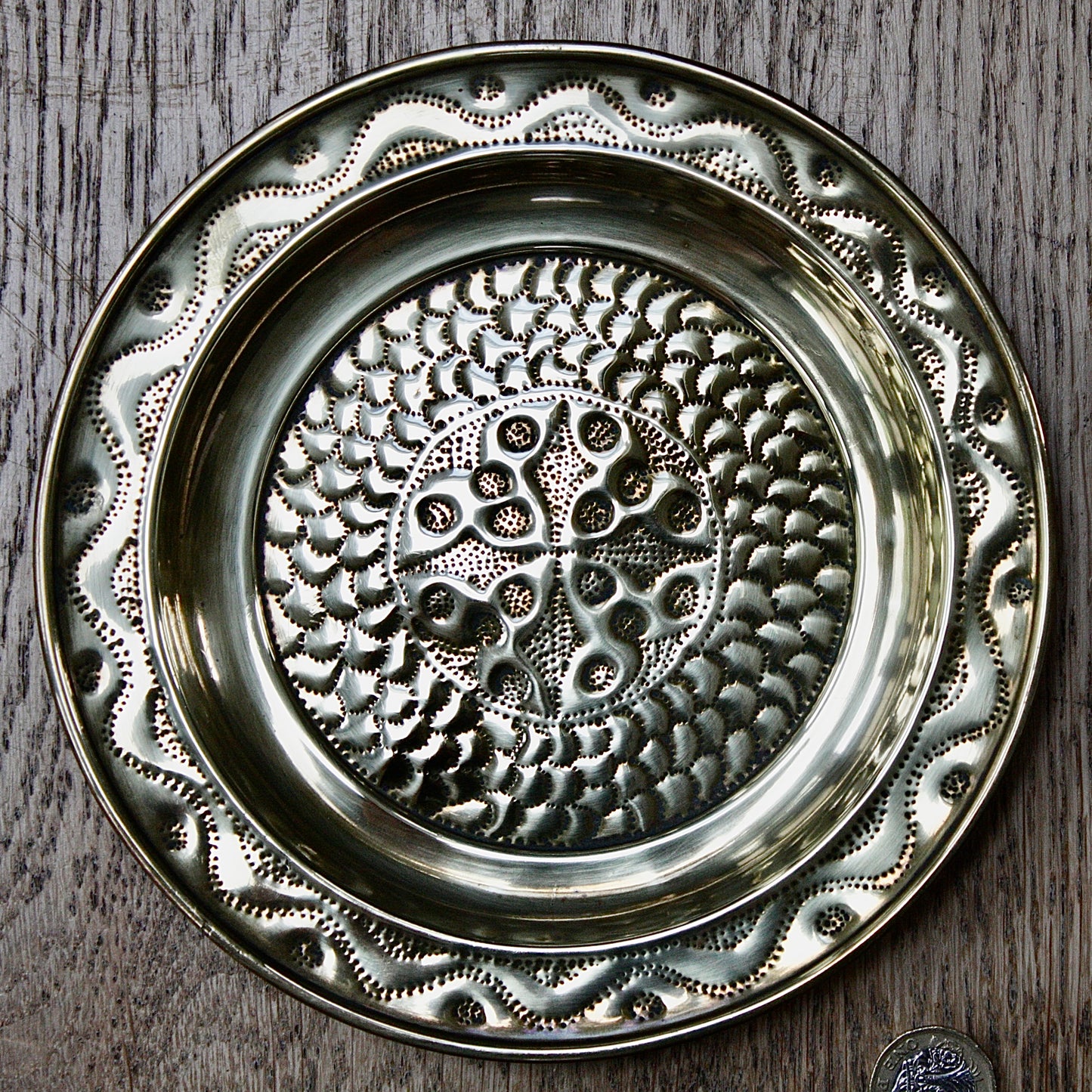 
                  
                    a pair of small embossed brass dishes from old calabar.
                  
                