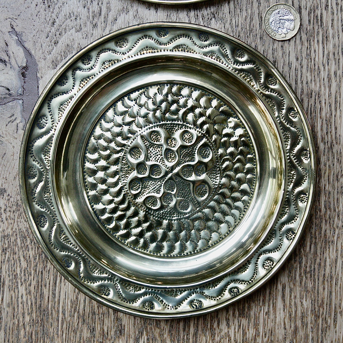 
                  
                    a pair of small embossed brass dishes from old calabar.
                  
                