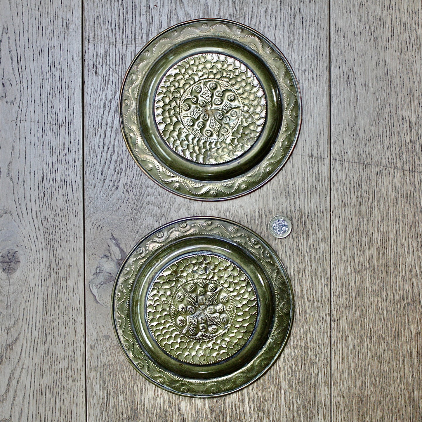 
                  
                    a pair of small embossed brass dishes from old calabar.
                  
                