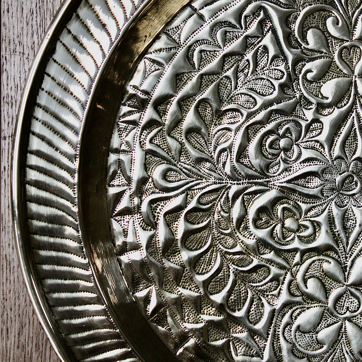 
                  
                    an african efik brass charger decorated with wild plants.
                  
                