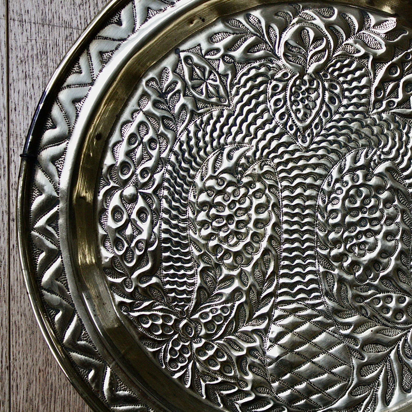 
                  
                    a magnificent african efic brass charger decorated with the bamboo palm
                  
                