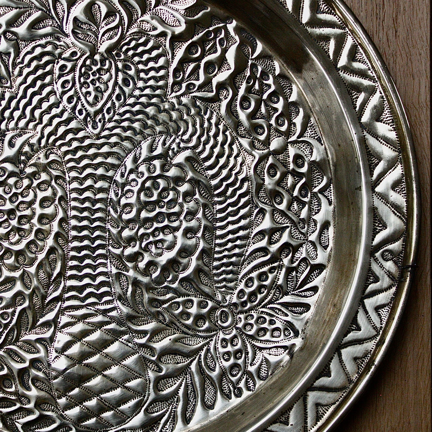 
                  
                    a magnificent african efic brass charger decorated with the bamboo palm
                  
                