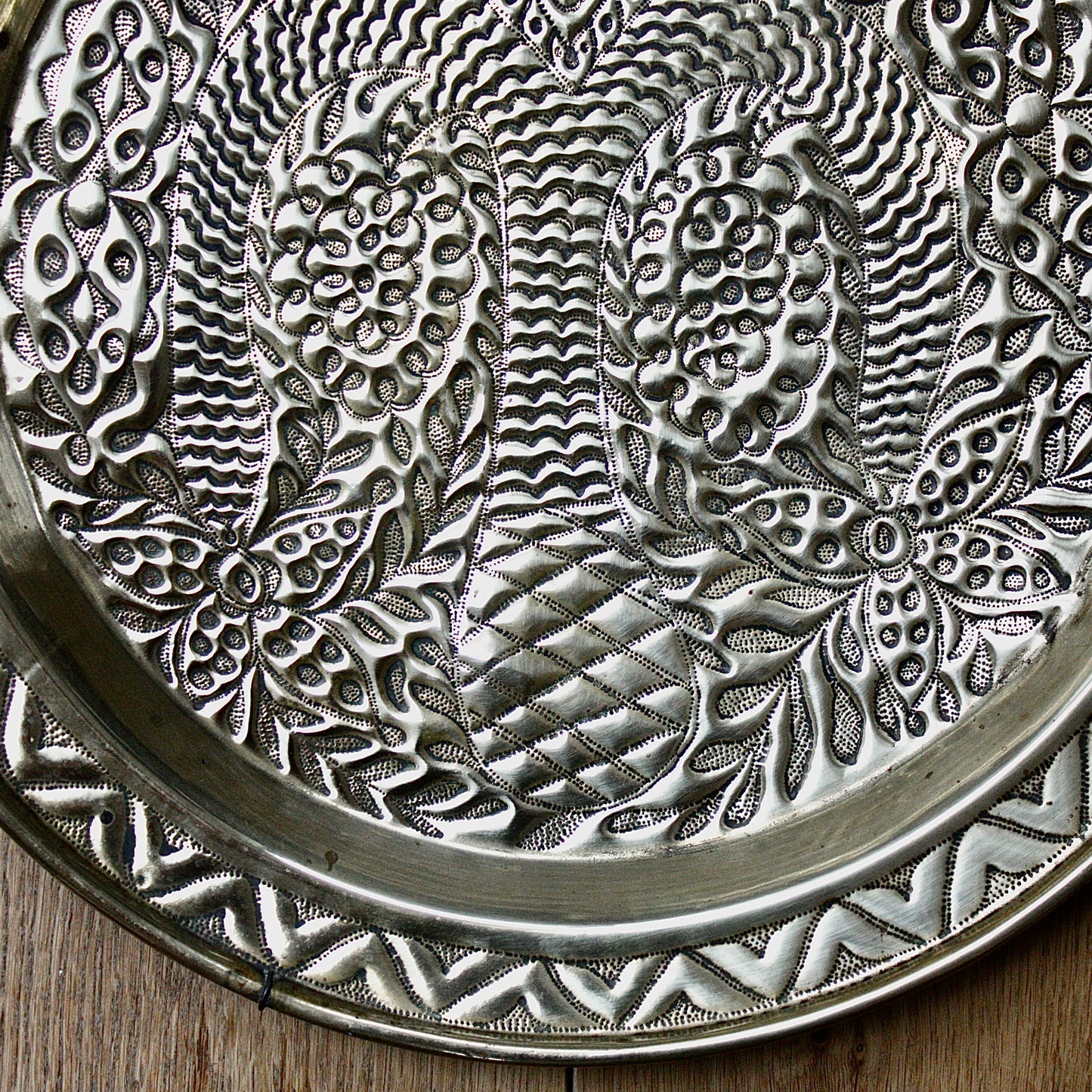 
                  
                    a magnificent african efic brass charger decorated with the bamboo palm
                  
                