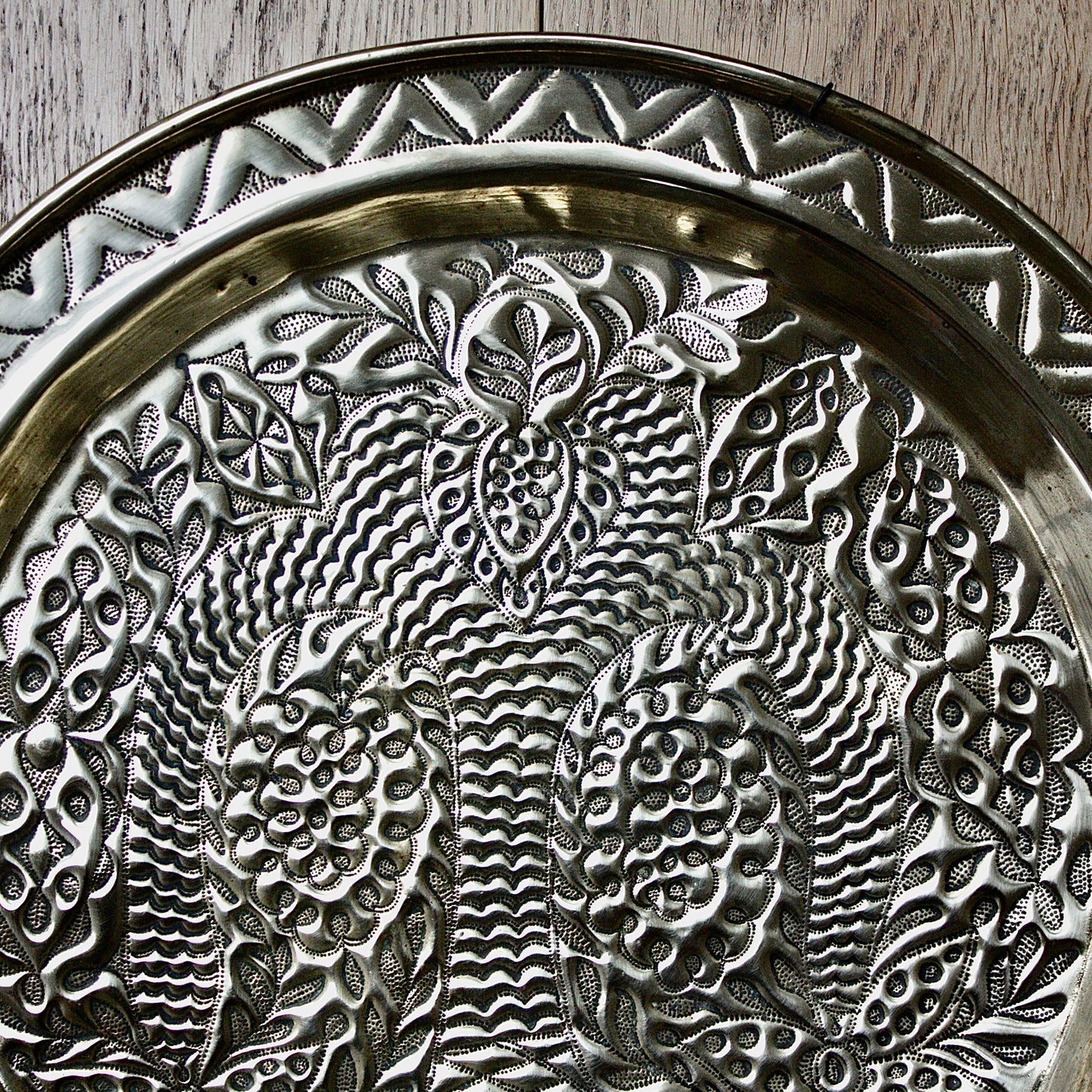 
                  
                    a magnificent african efic brass charger decorated with the bamboo palm
                  
                
