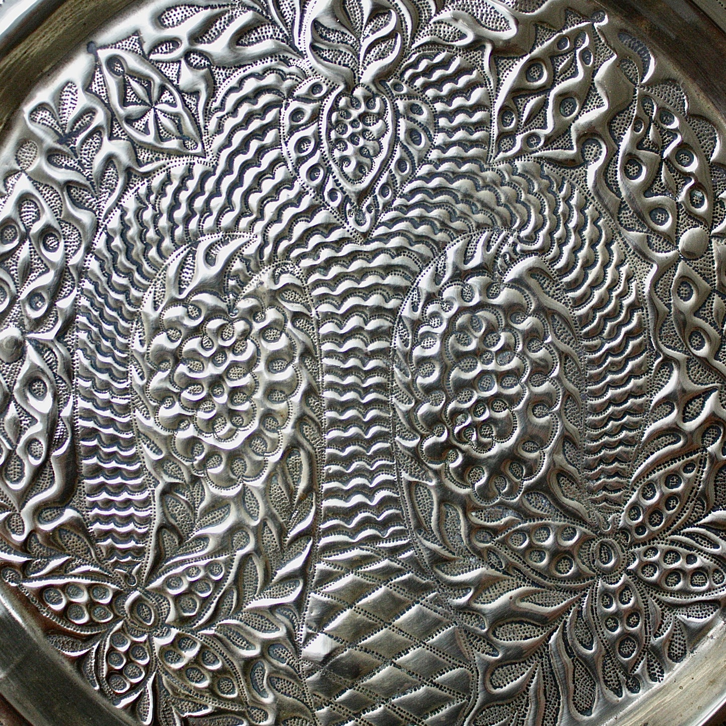 
                  
                    a magnificent african efic brass charger decorated with the bamboo palm
                  
                