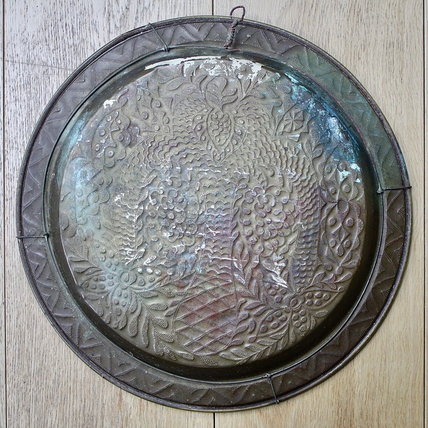 
                  
                    a magnificent african efic brass charger decorated with the bamboo palm
                  
                