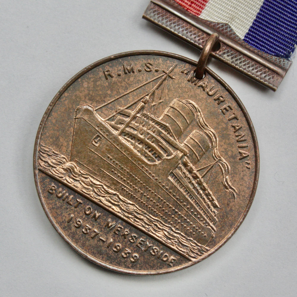 
                  
                    r.m.s Mauretania maiden voyage 1939 medallion.
                  
                