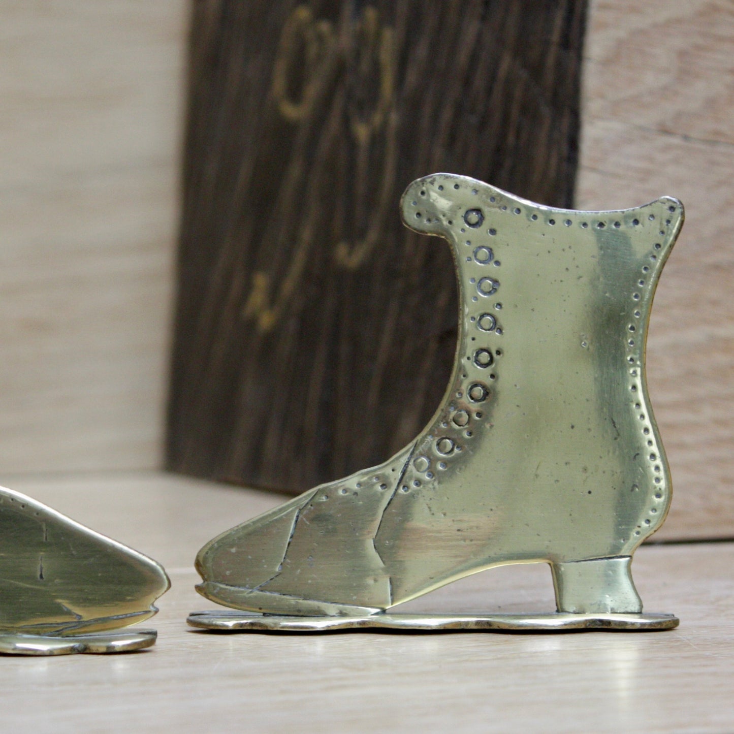 
                  
                    a small pair of antique folk art mantlepiece brass boots
                  
                