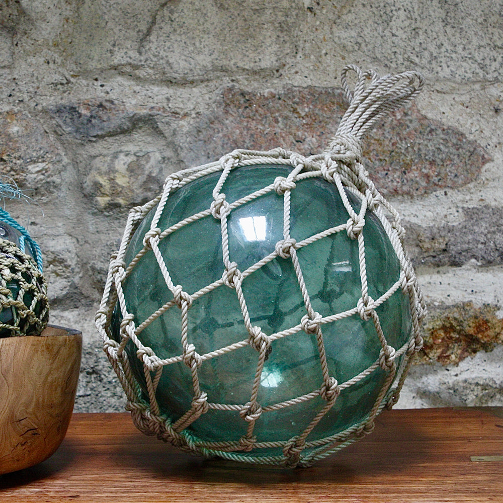 
                  
                    a large vintage glass fishing float.
                  
                